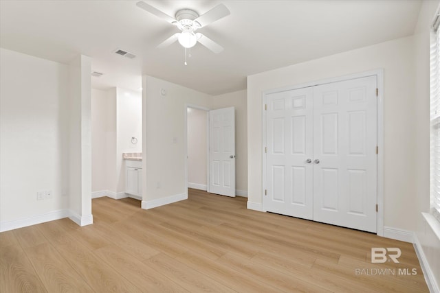4310 Lauder Ln, Orange Beach, AL 36561 - unfurnished bedroom with a closet, a ceiling fan, light wood-style flooring, baseboards, and visible vents