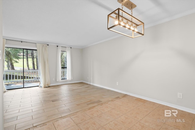 empty room featuring ornamental molding, baseboards, and an inviting chandelier