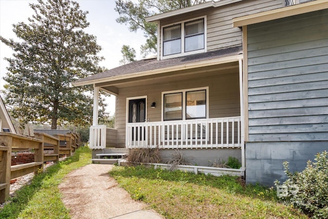 view of front of property with a porch and fence