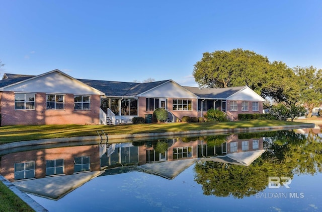 9577 Villas Dr, Foley, AL 36535 - rear view of property with a lawn and a water view