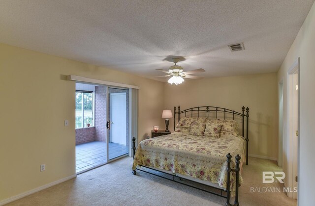 9577 Villas Dr, Foley, AL 36535 - carpeted bedroom with a textured ceiling, visible vents, baseboards, ceiling fan, and access to exterior