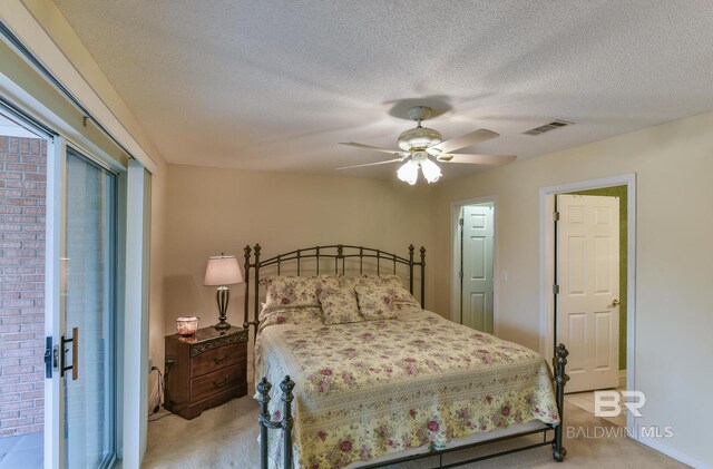 9577 Villas Dr, Foley, AL 36535 - bedroom featuring light carpet, visible vents, ceiling fan, and a textured ceiling