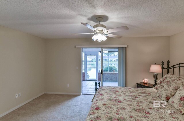 9577 Villas Dr, Foley, AL 36535 - bedroom featuring a ceiling fan, a textured ceiling, access to outside, baseboards, and light colored carpet