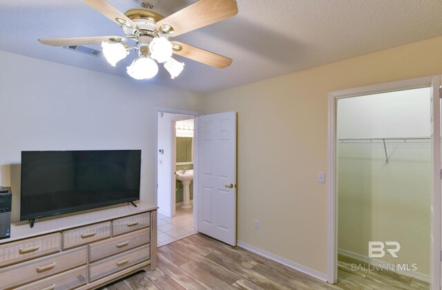 9577 Villas Dr, Foley, AL 36535 - bedroom with a closet, a textured ceiling, visible vents, and light wood-style floors