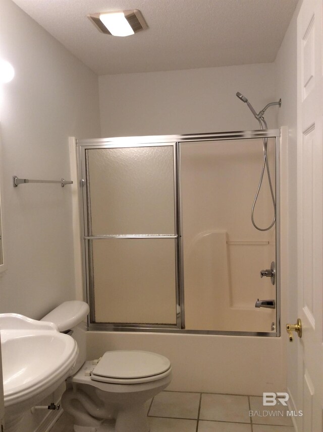 9577 Villas Dr, Foley, AL 36535 - bathroom with toilet, a sink, enclosed tub / shower combo, tile patterned flooring, and visible vents