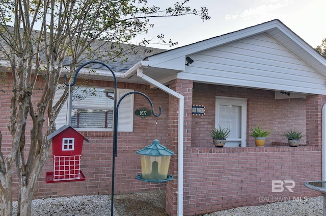9577 Villas Dr, Foley, AL 36535 - view of property exterior with brick siding and roof with shingles