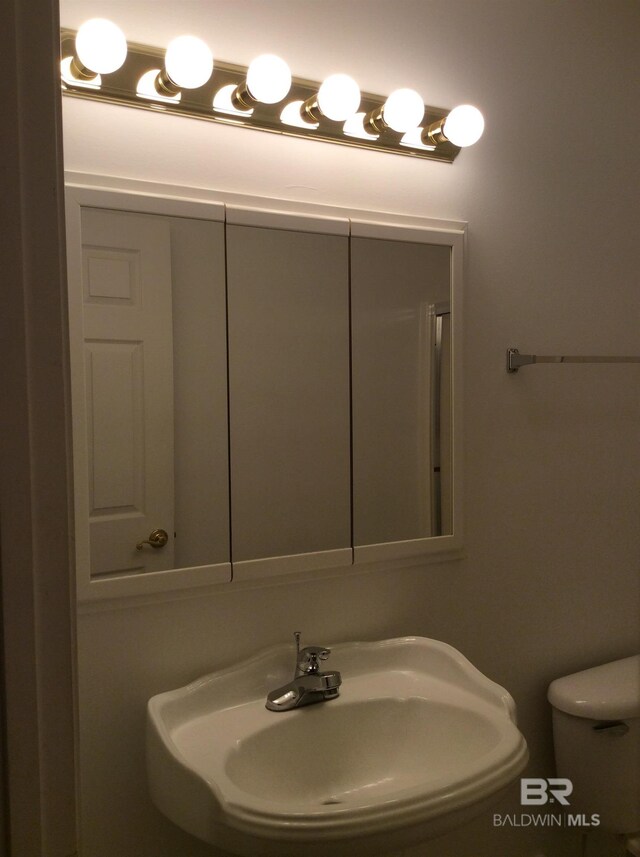 9577 Villas Dr, Foley, AL 36535 - half bathroom featuring toilet and a sink
