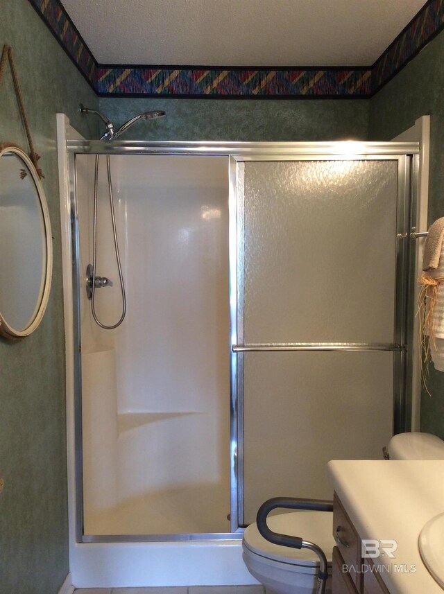 9577 Villas Dr, Foley, AL 36535 - bathroom with vanity, toilet, and a shower stall