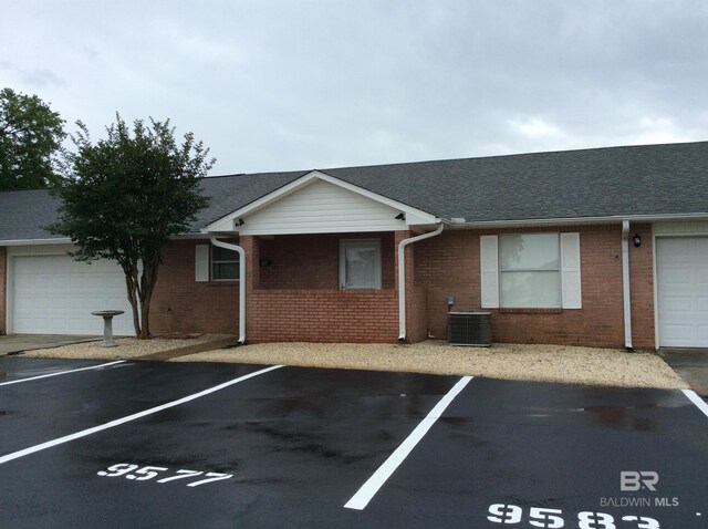 9577 Villas Dr, Foley, AL 36535 - view of front of home with brick siding, central AC unit, and uncovered parking