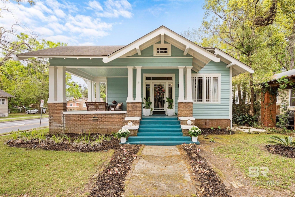 view of front of home with a front lawn and covered porch