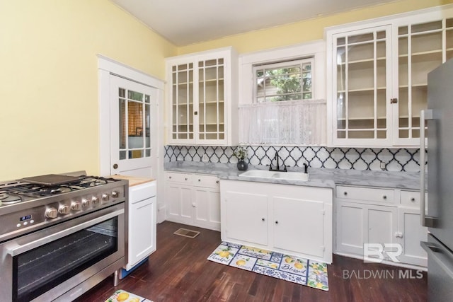 kitchen featuring white cabinets, appliances with stainless steel finishes, tasteful backsplash, and sink