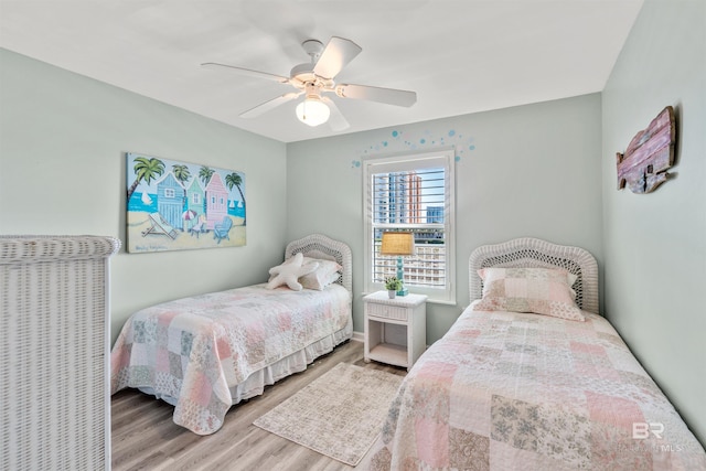 bedroom featuring a ceiling fan and wood finished floors