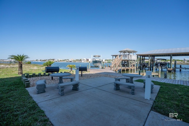 view of patio / terrace with a water view, boat lift, and a boat dock