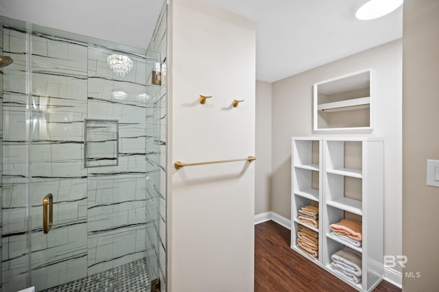 bathroom with wood-type flooring and a shower with door