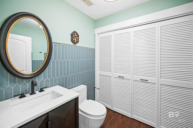 bathroom featuring vanity, toilet, and wood-type flooring