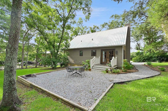 rear view of property with a yard