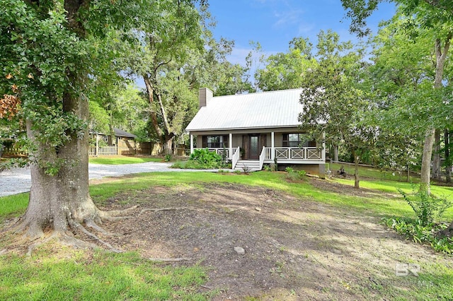 view of front of house with a porch and a front lawn