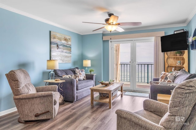 living room featuring wood finished floors, crown molding, and french doors