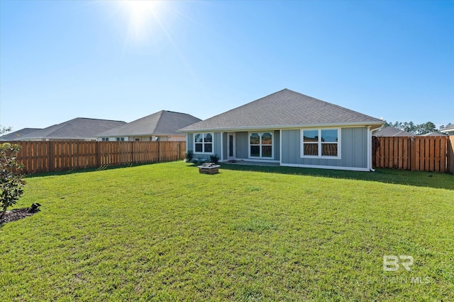 rear view of property featuring a yard