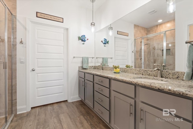 4299 Montague Dr, Gulf Shores, AL 36542 - full bath with a stall shower, wood finished floors, double vanity, and baseboards