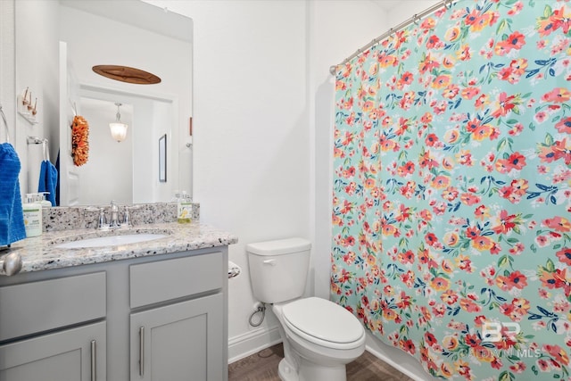 4299 Montague Dr, Gulf Shores, AL 36542 - full bathroom with toilet, wood finished floors, vanity, baseboards, and curtained shower