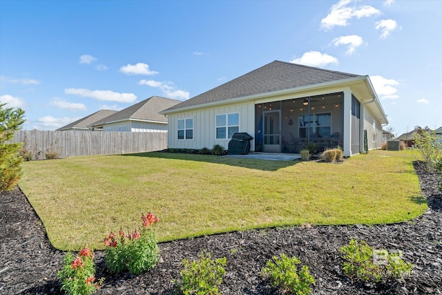 4299 Montague Dr, Gulf Shores, AL 36542 - back of property featuring board and batten siding, a sunroom, central AC, and roof with shingles