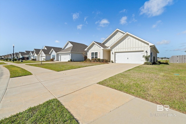 4299 Montague Dr, Gulf Shores, AL 36542 - view of front of house featuring board and batten siding, driveway, a front lawn, a garage, and a residential view