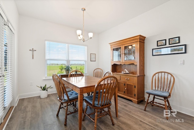 4299 Montague Dr, Gulf Shores, AL 36542 - dining room with wood finished floors, a chandelier, and baseboards