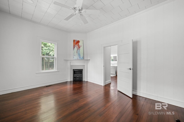 unfurnished living room with a ceiling fan, crown molding, a fireplace with flush hearth, baseboards, and dark wood-style floors