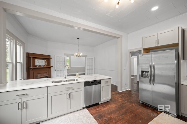 kitchen featuring an inviting chandelier, ornamental molding, dark wood-style floors, a sink, and appliances with stainless steel finishes