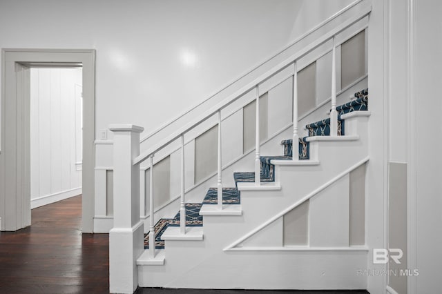 stairway with wood finished floors