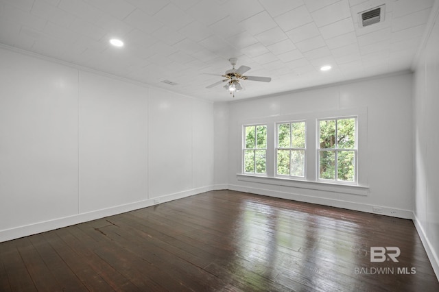unfurnished room featuring crown molding, dark wood-style flooring, ceiling fan, and visible vents