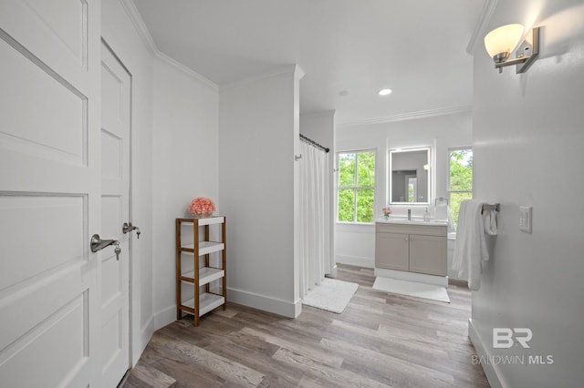 full bath featuring vanity, recessed lighting, baseboards, wood finished floors, and ornamental molding
