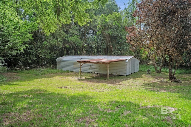 view of yard with a storage shed and an outbuilding