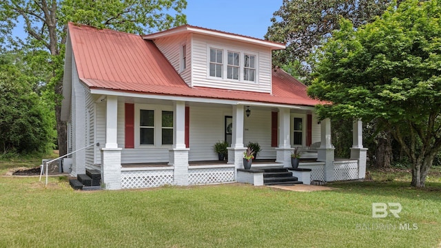 bungalow-style house with a porch, a front yard, and metal roof