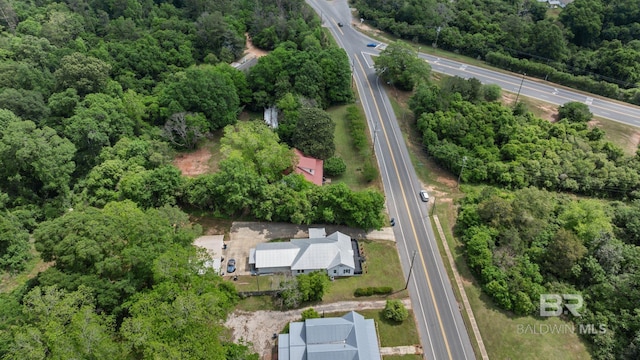 birds eye view of property featuring a view of trees