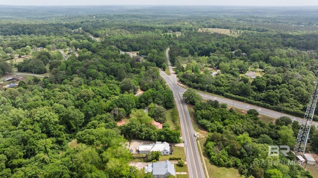 birds eye view of property with a wooded view