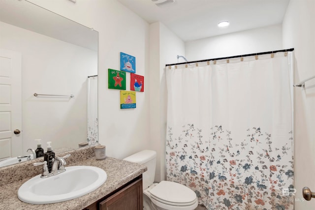 bathroom featuring vanity and toilet