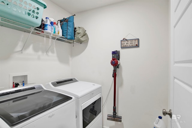 clothes washing area featuring washer and clothes dryer and washer hookup