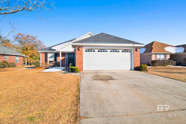 single story home featuring a garage and a front lawn