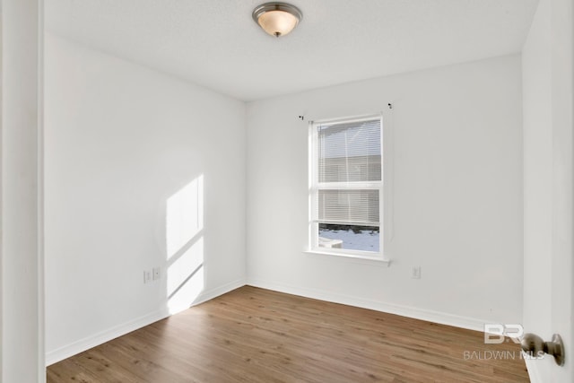 spare room with hardwood / wood-style floors