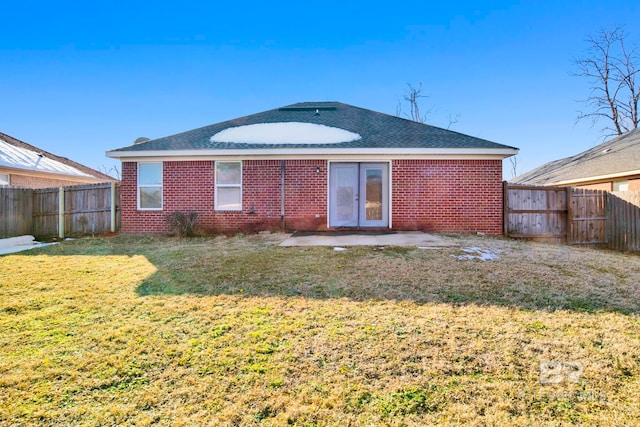 rear view of house with a yard and a patio