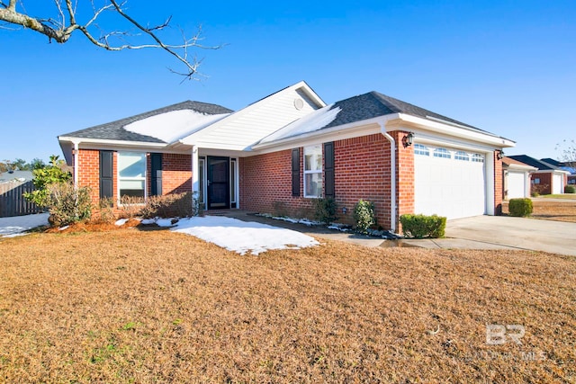 ranch-style house featuring a garage and a front yard