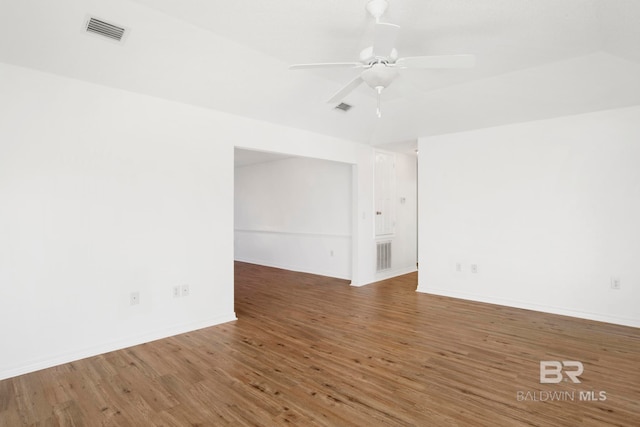 spare room with dark hardwood / wood-style floors and ceiling fan