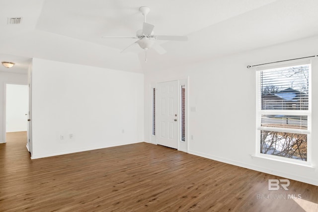 spare room with dark wood-type flooring and ceiling fan