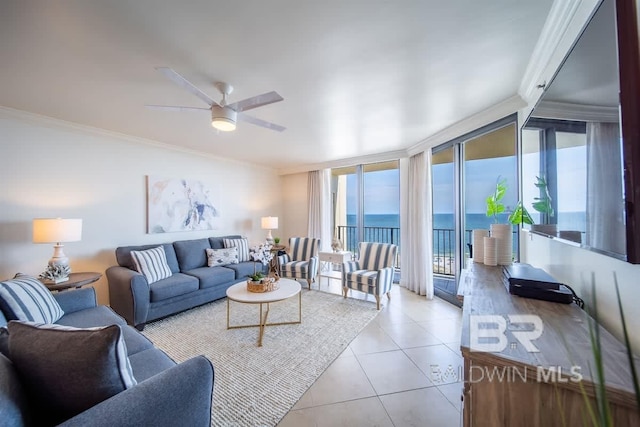 tiled living area featuring expansive windows, ornamental molding, and ceiling fan