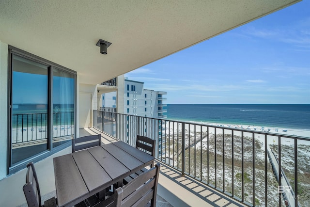 balcony with a water view and a beach view