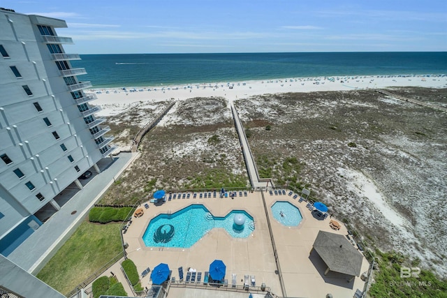 aerial view featuring a water view and a view of the beach