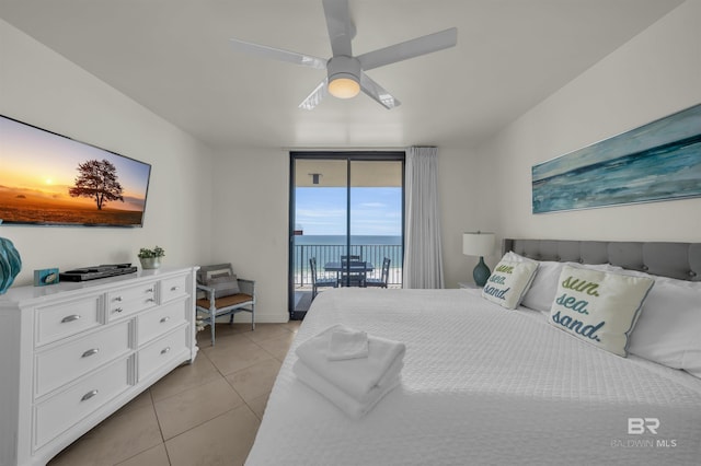 bedroom with a water view, access to exterior, a wall of windows, ceiling fan, and light tile patterned flooring
