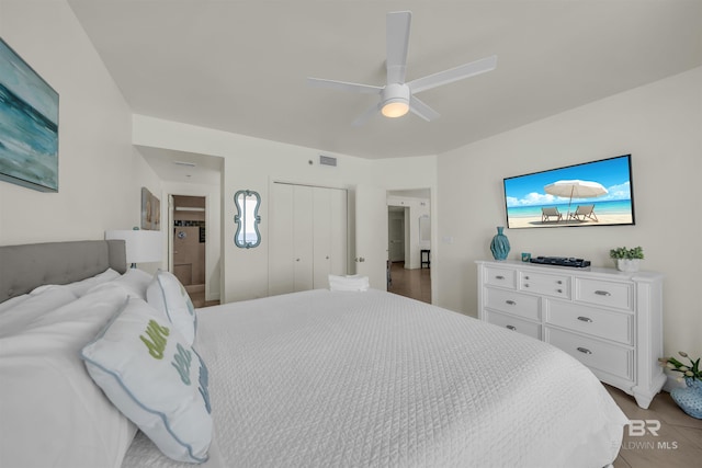 bedroom with a closet, ceiling fan, and visible vents